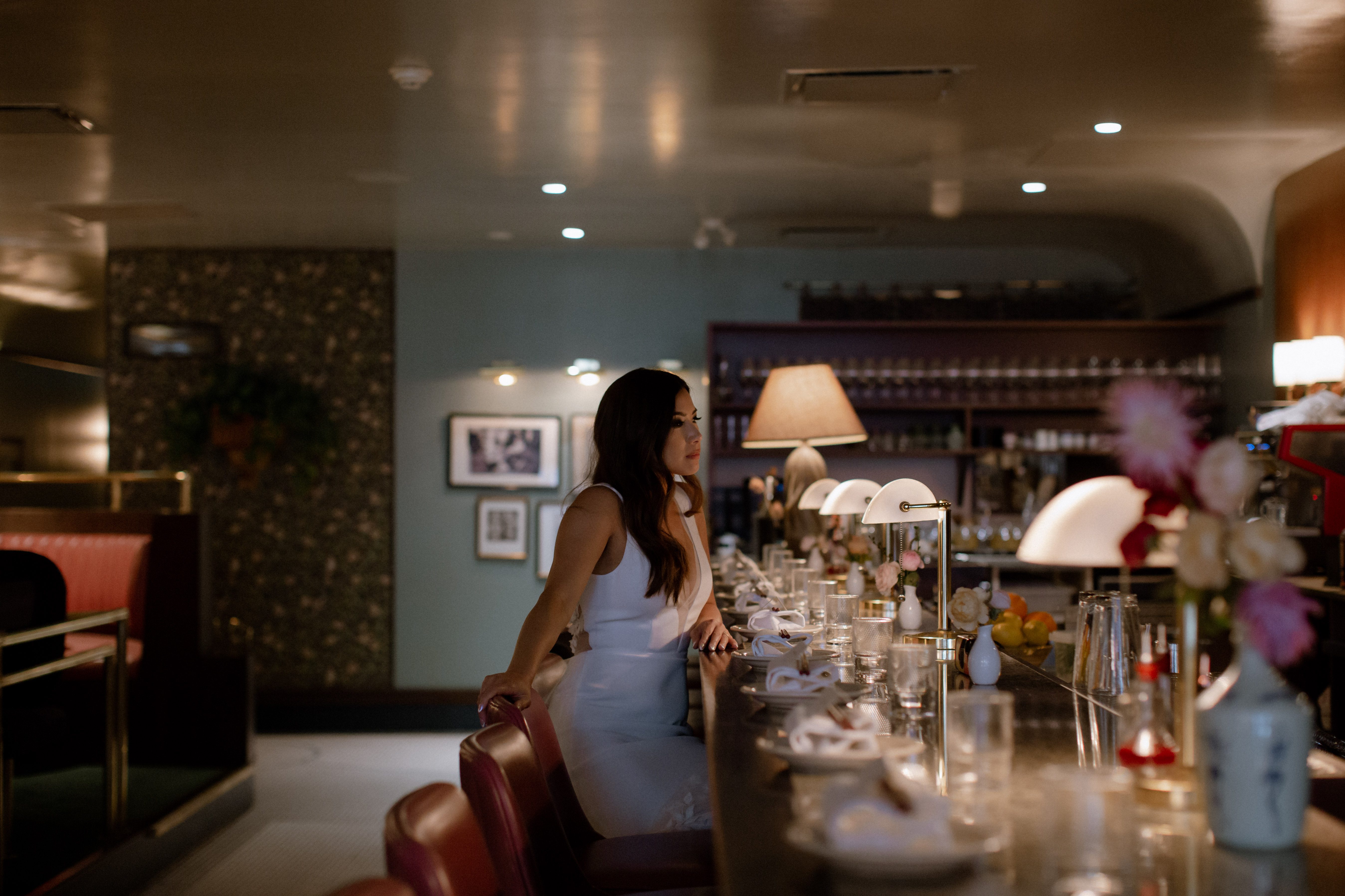 A bride sitting at the bar alone in Kissa Tanto, Vancouver