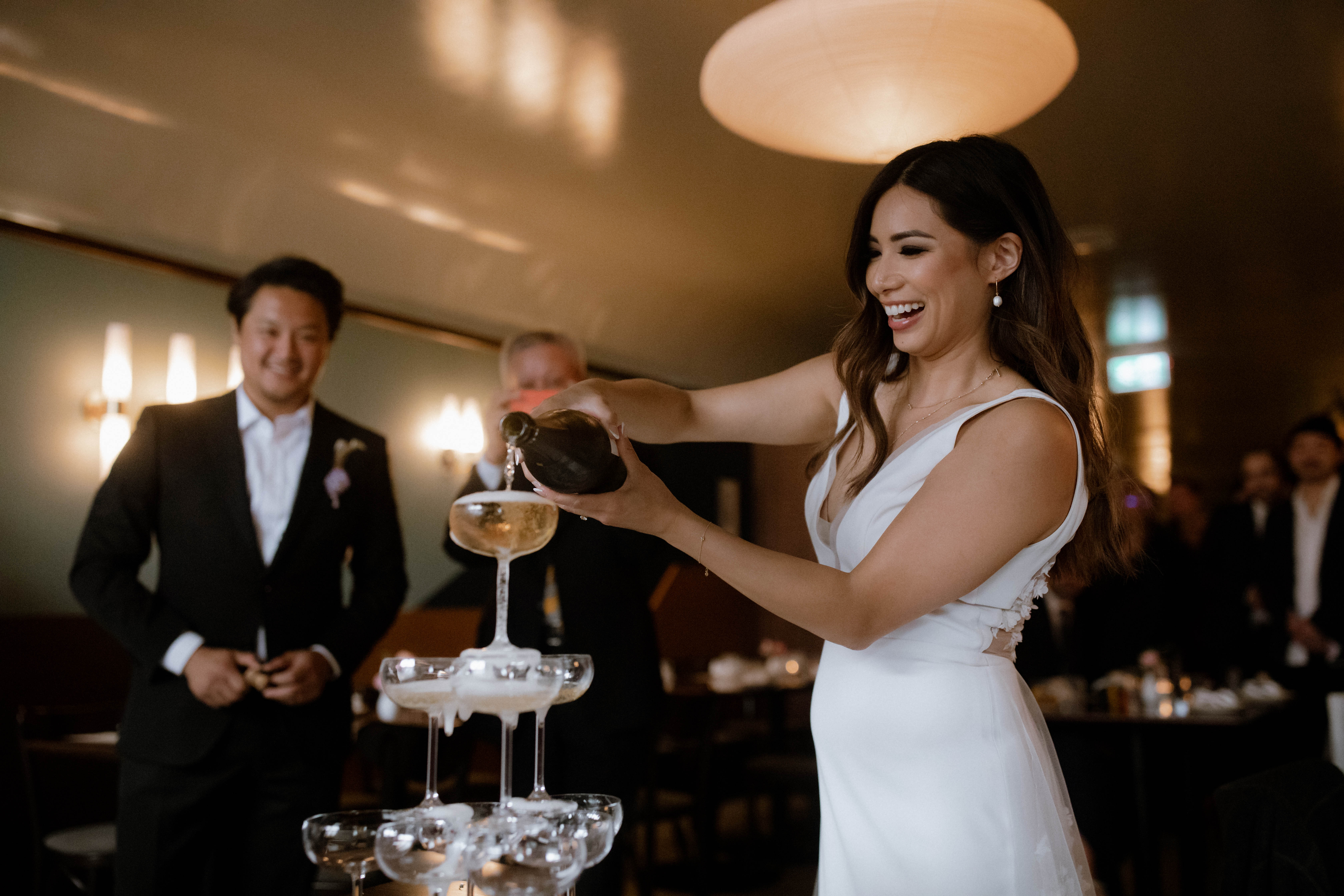 Bride doing a champagne tower pour