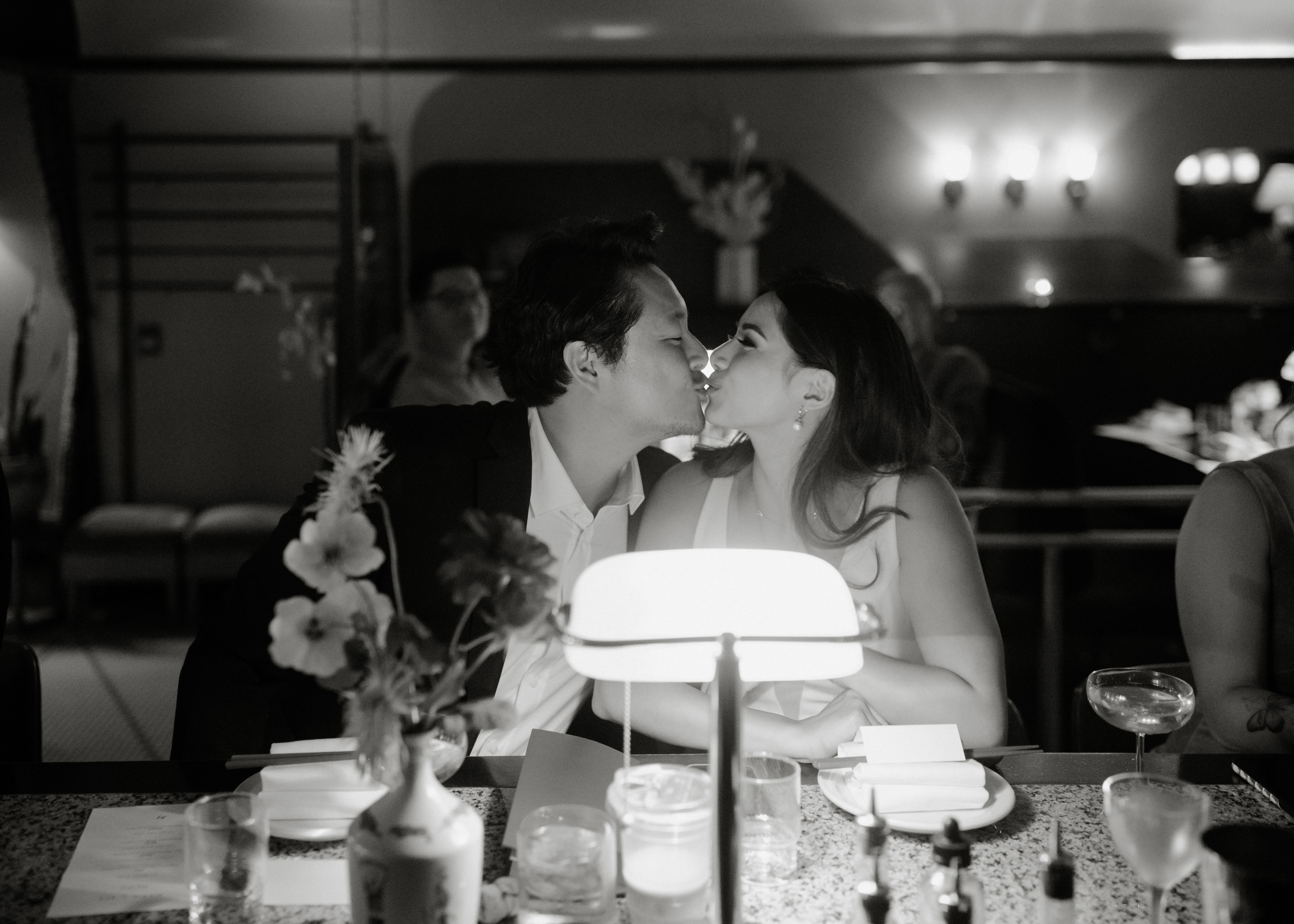 Wedding couple kissing by the bar in Kissa Tanto Vancouver