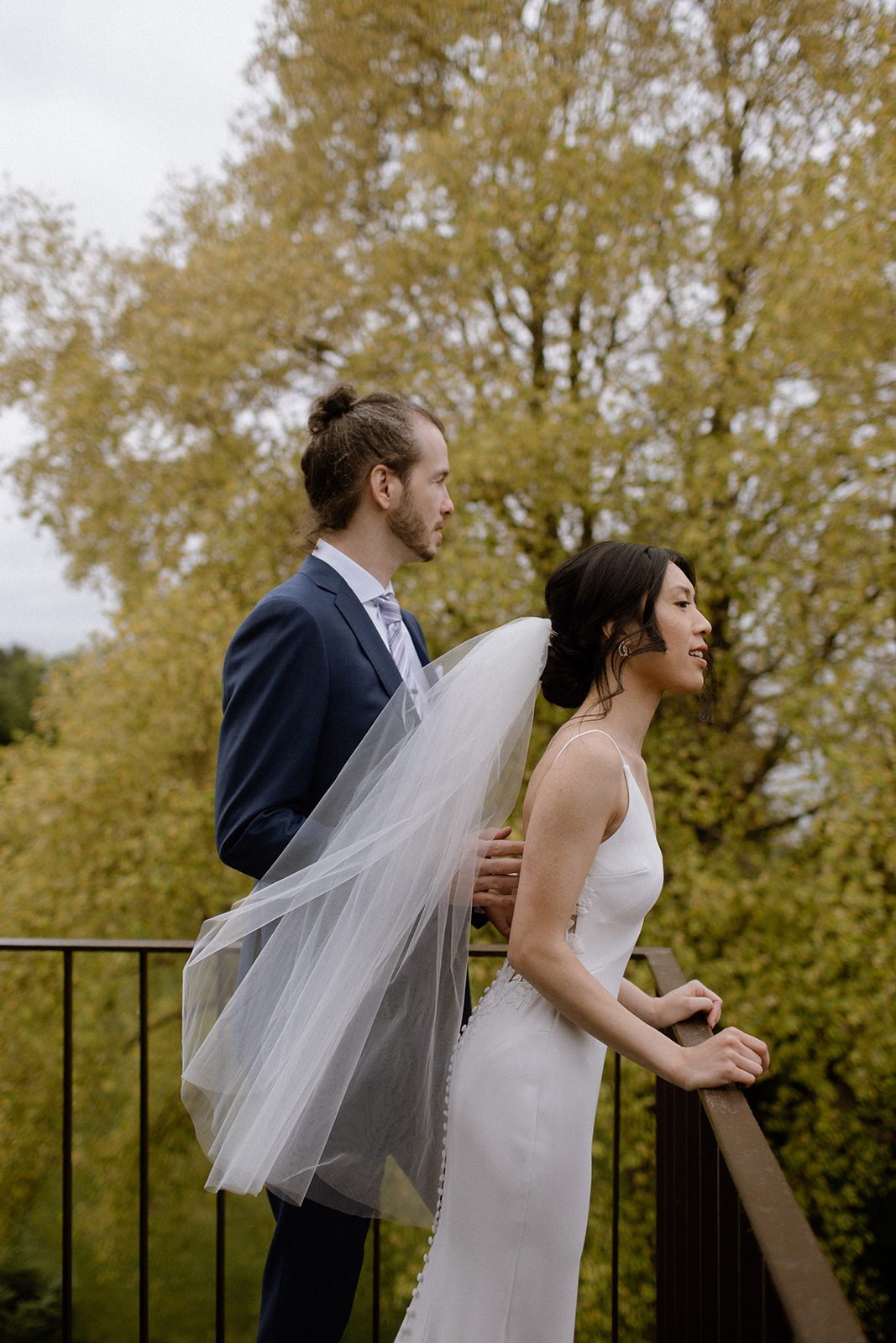 Bride and groom on a rooftop of Cecil Green Park House, overlooking their ceremony spot.