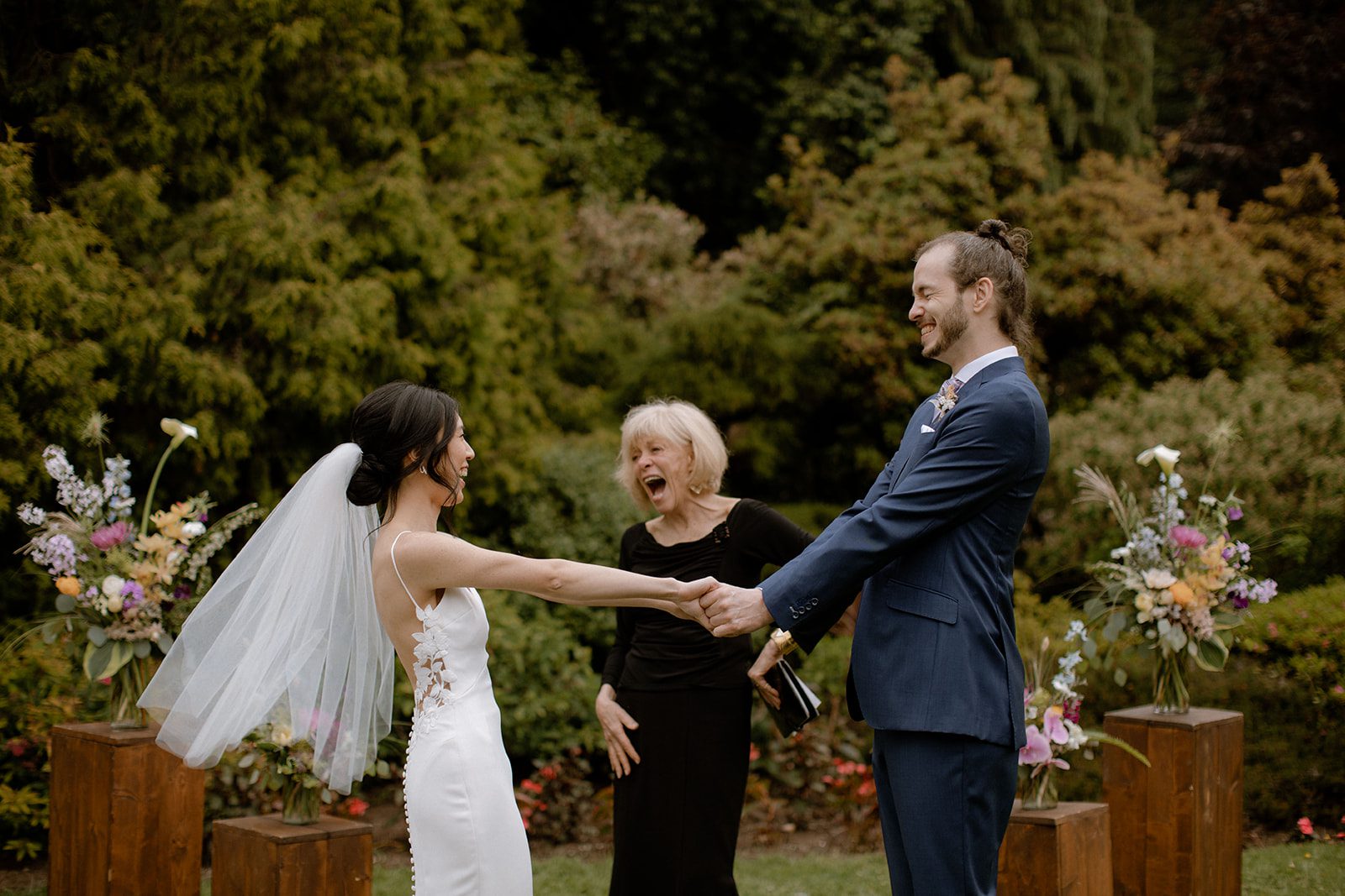 bride and groom holding hands and smiling after being married at Cecil Green Park House.
